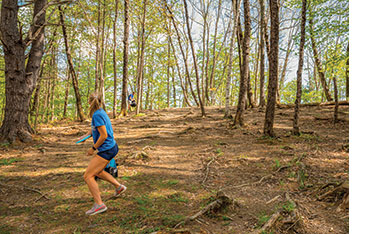 Angie Dubois shoots her disc toward the basket at Bittersweet Ridge Disc Golf course