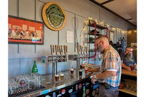 Joel Fitzpatrick pours a flight for a thirsty patron at Katahdin Brew Works.